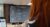 woman writing a Python code on a desktop