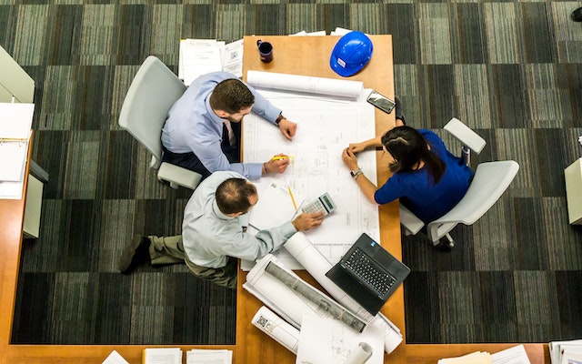 people discussing a house plan
