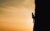 man climbing vertically a mountain