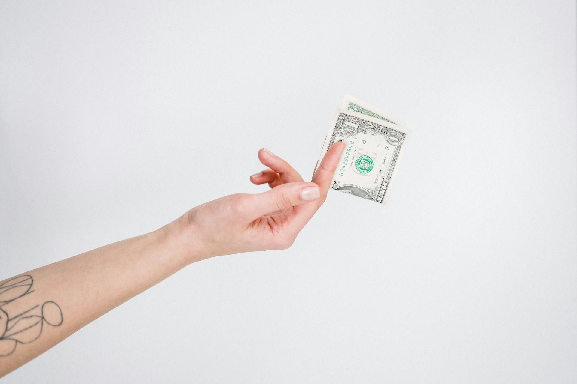 hand with 1 dollar