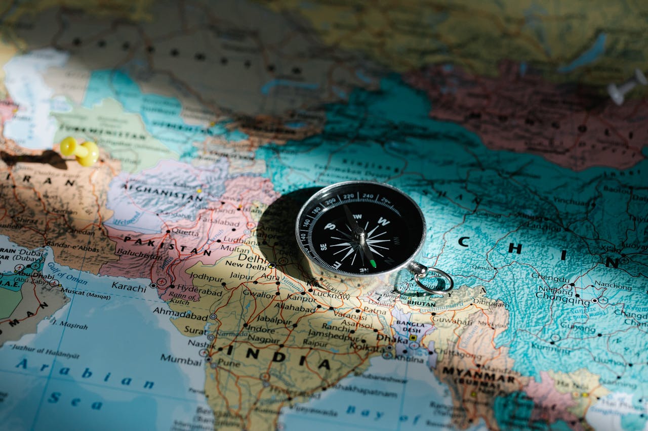 world map with a compass